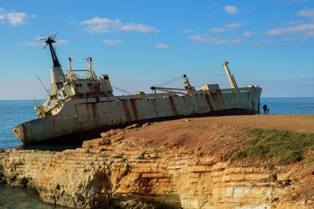 Paphos, Cyprus - January 11, 2020: Shipwreck near Paphos, Cyprus. Father and son looking to shipのeditorial素材