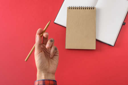 Dirty left hand in red shirt after writing. Left hander day concept.の写真素材