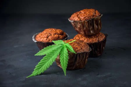 Chocolate muffin or cake with cannabis leaf, cbd infusedの写真素材