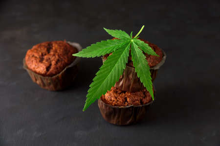 Chocolate muffin or cake with cannabis leaf, cbd infusedの写真素材