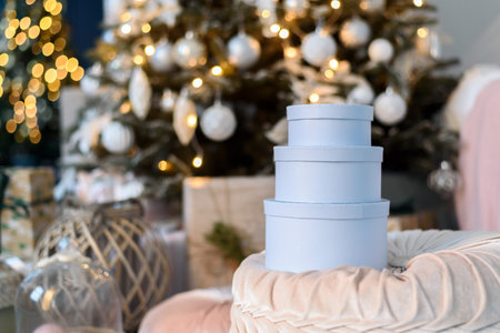 Stack of round blue gift boxes with Christmas decorations
