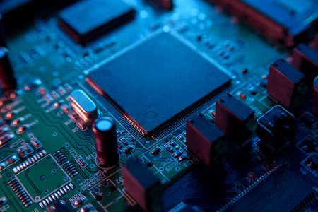 Microcircuit with chip close up with neon lighting. Chip shortageの写真素材