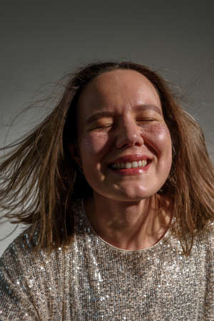 Happy smiling woman with sparkles on her face as frecklesの写真素材