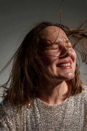 Happy smiling woman with sparkles on her face as frecklesの写真素材