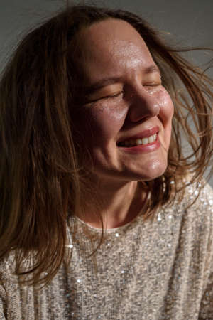Happy smiling woman with sparkles on her face as frecklesの写真素材