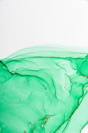 Abstract alcohol ink fluid art background. Green color with goldの写真素材