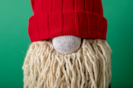 Handmade Christmas gnome on green background. Upcycle, made from old socks. Close up portraitの写真素材