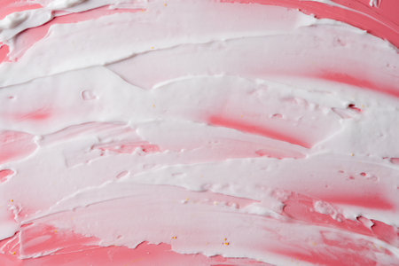 White facial cream smears on pink background. Surface covered by creamの写真素材