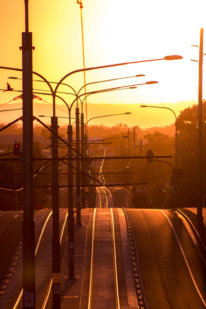 Road with tram line and streetlights in the sunset. Gold Coast, Australiaの写真素材