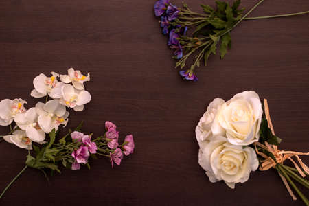 Bunches of flowers on a dark wooden table topの写真素材