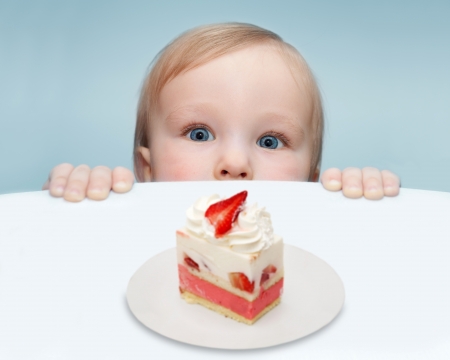 Baby and cake filled with strawberriesの写真素材