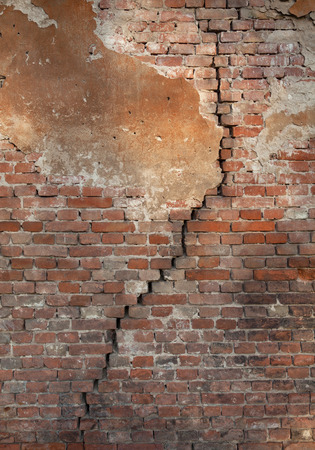 Old brick wall with cracksの写真素材