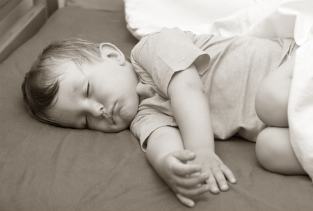 Portrait of a little boy sleeping in bedの写真素材
