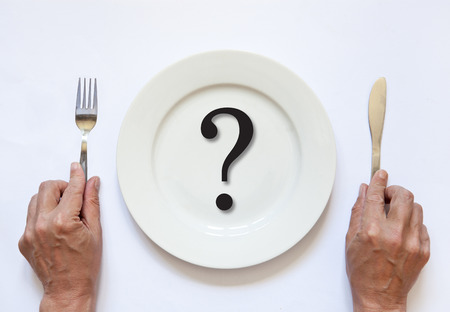 empty plate with cutlery in handの写真素材