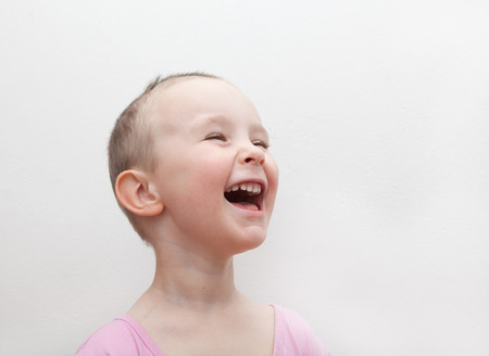 Laughing boy in a pink shirtの写真素材