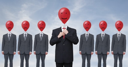 Laughing businessman in a suit with a red tieの写真素材