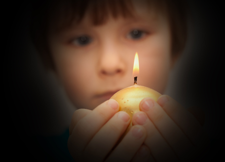 child watches through a frosted window birdの写真素材