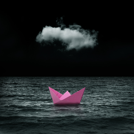 abandoned pink paper ship at seaの写真素材