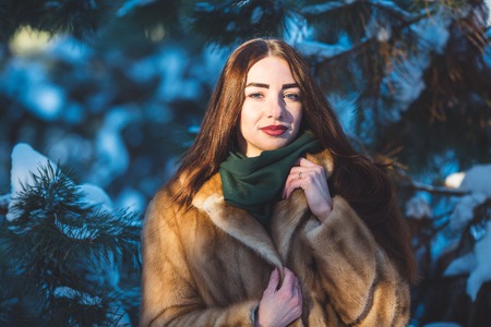 Beautiful young girl in winter forestの写真素材
