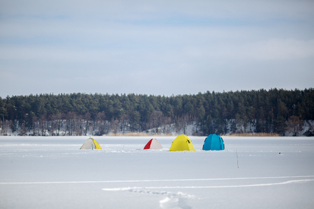 Tents on winter fishing on a frozen lake.の写真素材