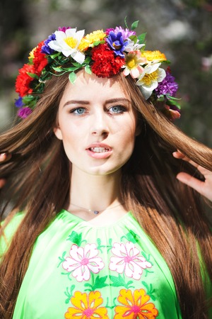 Portrait of beautiful natural woman in nice green dress in the garden of apple.の写真素材