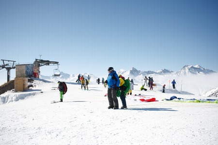 Gudauri, Georgia - March 6, 2017. Winter paragliding in caucasus mountains over high peaks and valley.のeditorial素材