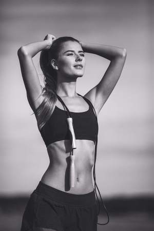 Cute fit woman with skipping ropeの写真素材