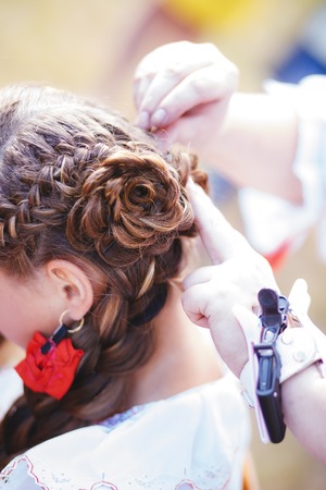Hairdresser braid ones hair for girl outdoor