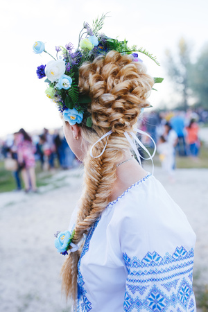 Creative braid hairstyle with blue flowers for blonde girlの写真素材