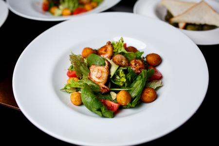 Cheese ball under hazelnut with mix of salad.の写真素材
