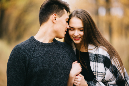 A loving couple walking in the forest. Autumn mood and colors around.の写真素材