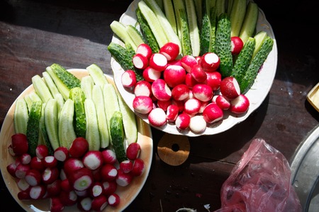 Set of vegetables for salad: lettuce, cucumbers, radish, green onions and green leafs of sorrelの写真素材