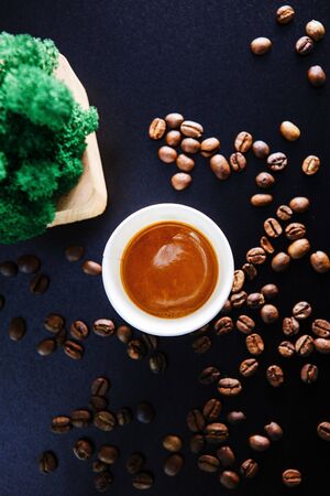 Cup of coffee on black background with beans. View from above.の写真素材