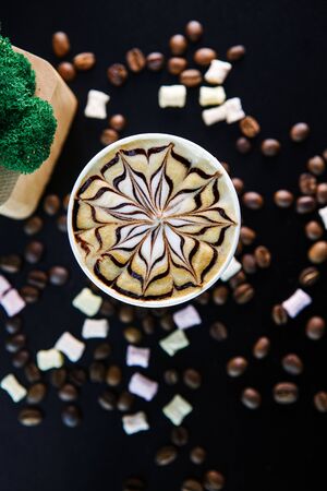 Cup of coffee on black background with beans. View from above.の写真素材