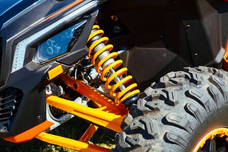 Atv off road bike front wheel tire, head light, suspersion part detail close up.