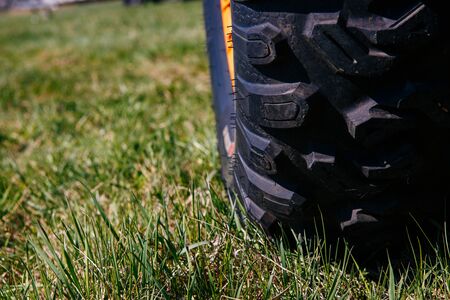 Wheel of quad bike atv on the grassの写真素材
