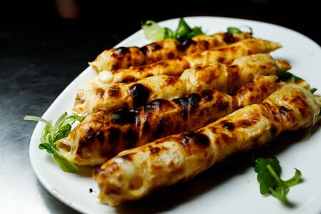 Baked suluguni on a white plate.