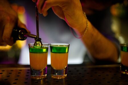 The bartender is preparing a cocktail.