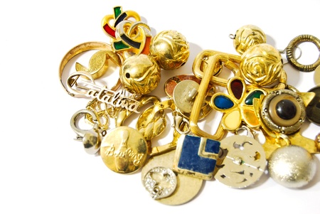 pile of golden silver accessories and jewelry closeup isolated on white background