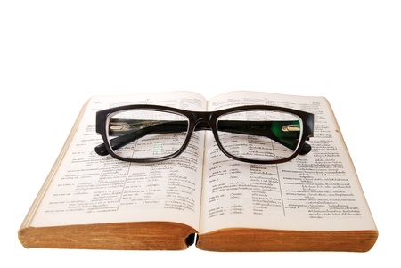 closeup of old dictionary and black glassesの写真素材