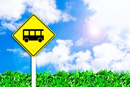 bus stop sign on beautiful sky and grass field backgroundの写真素材