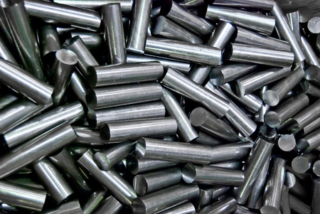 pile of metal pipes in factory , the waste from process , closeup backgroundの写真素材