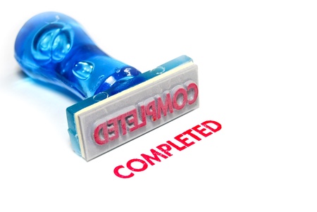 completed letter on blue rubber stamp isolated on white backgroundの写真素材