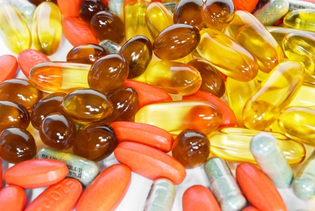 colorful vitamin and medicine pills closeup on white background