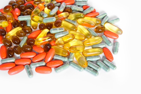 colorful vitamin and medicine pills closeup on white background