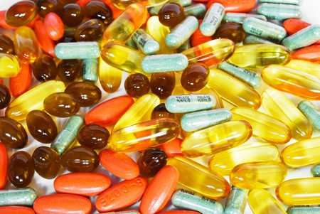 colorful vitamin and medicine pills closeup on white backgroundの写真素材