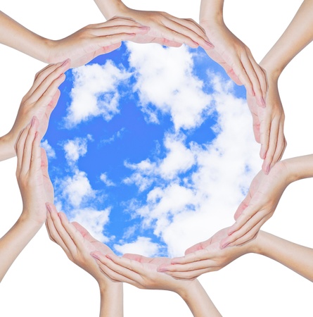 Hands forming a circle shape around blue sky backgroundの写真素材
