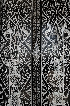 Traditional Thai style painting art on door in Buddha Templeのeditorial素材