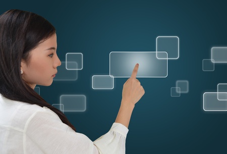 Business woman pressing on a flow of buttonsの写真素材