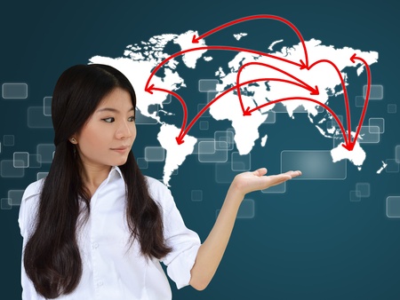 Business woman presenting network on world mapの写真素材